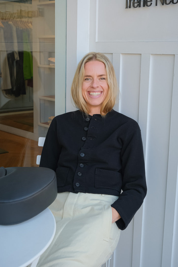 Black cardigan jacket from Auralee. Button front and long sleeves with two front pockets. Available in Charlotte, NC and Brentwood, CA.