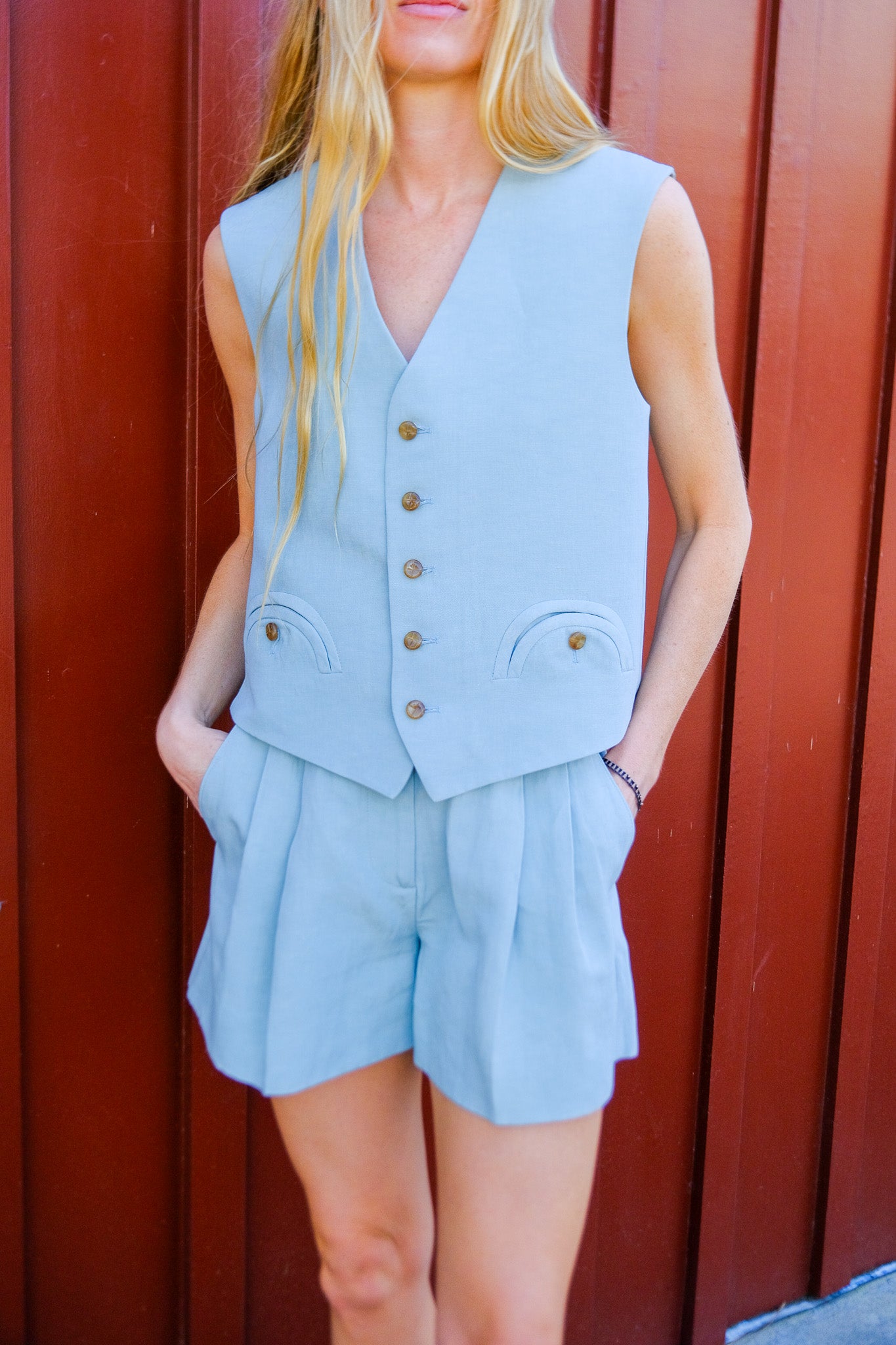 BLAZE | ZENITH FERAL GILET_SUGAR | Silk and linen blend gilet | Single breasted vest | Straight, yet slightly oversized fit | No lapels | External smiley pockets | Loden effect button closure | Back martingale | Ice blue hue: 'Sugar' color | Composition: 62% Silk 38% Linen, Lining: Viscose | Made in Italy | Available in Brentwood, CA