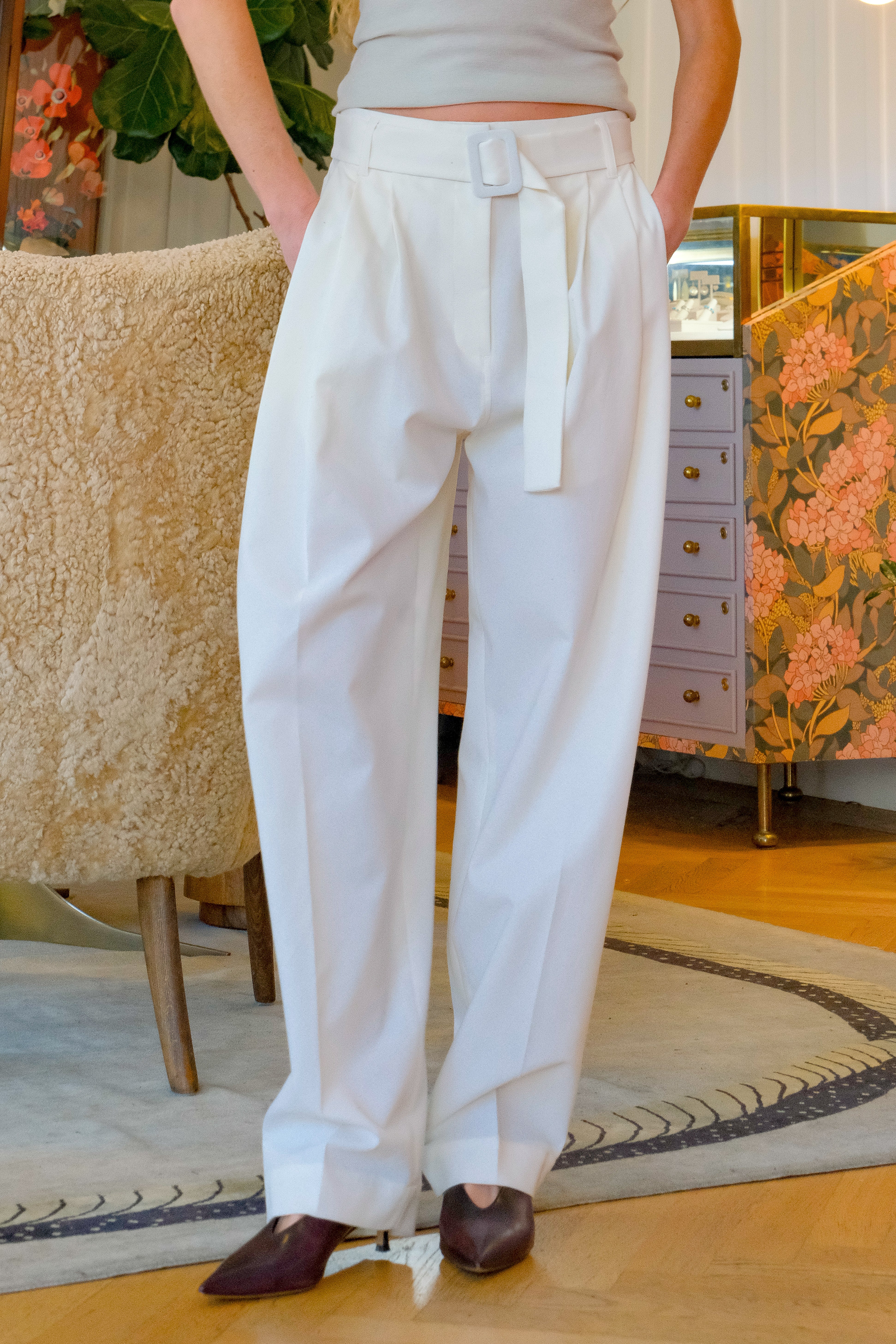 Milk white pleated cotton trousers from CO with a tailored silhouette and front pleat detailing. Available in Brentwood, CA and Charlotte, NC.