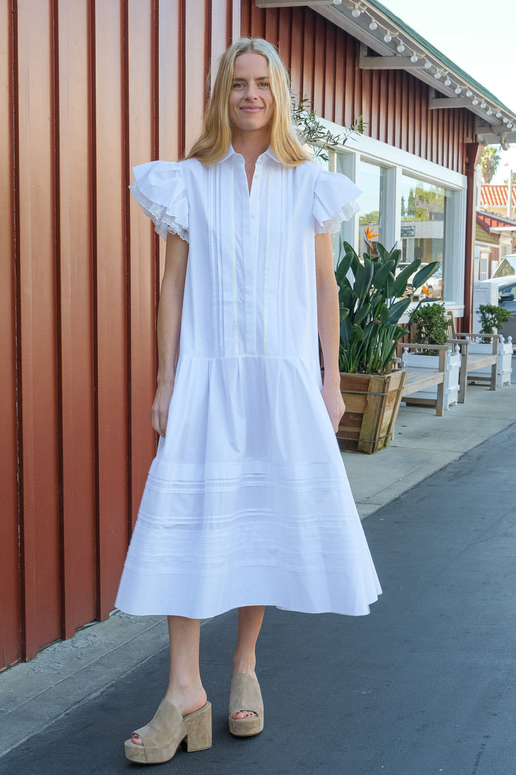 Lee Mathews white midi dress with drop waist and ruffle sleeves. Available in Charlotte, NC and Brentwood, CA.