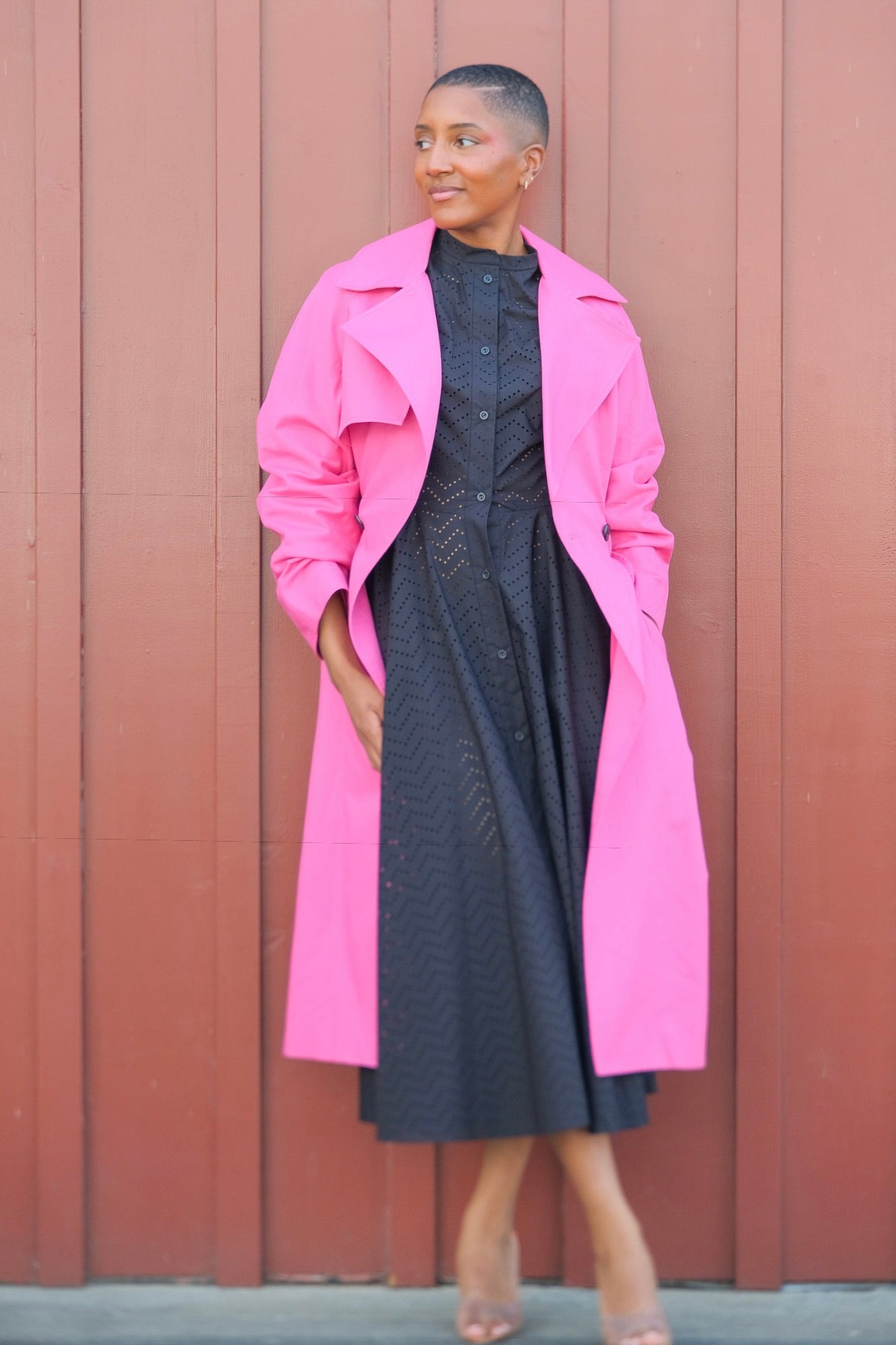 Bright pink fluid trench coat from Martin Grant with classic detailing and a softly draping silhouette. Available in Brentwood, CA and Charlotte, NC.