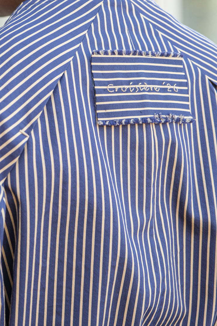 Long blue and white striped dress with a belted waist and double pearl pins located in Charlotte, NC and Brentwood, CA.