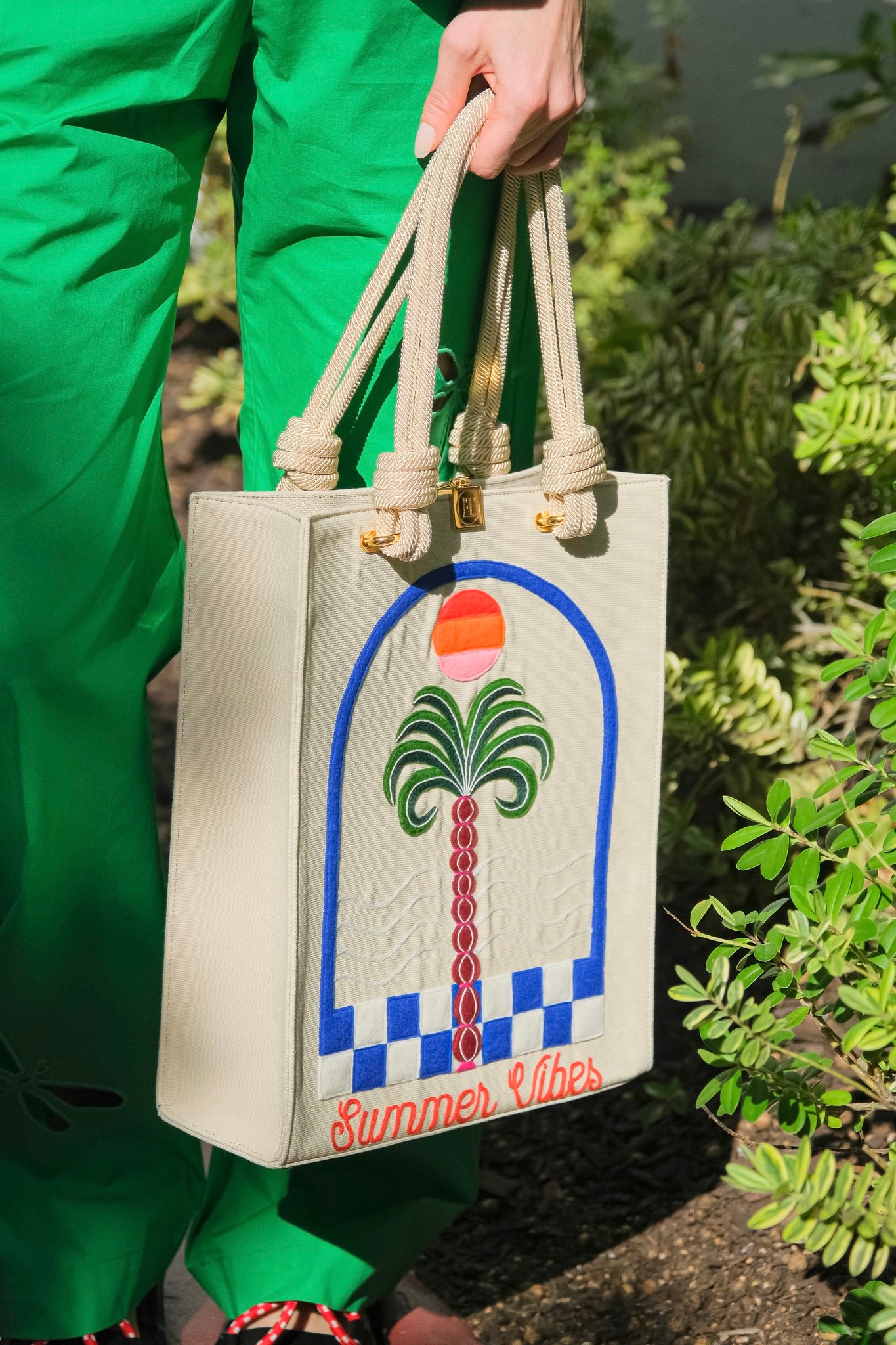 "Summer Vibes" tote from Olympia Le Tan with a palm tree design and embroidery. Available in Brentwood, CA.