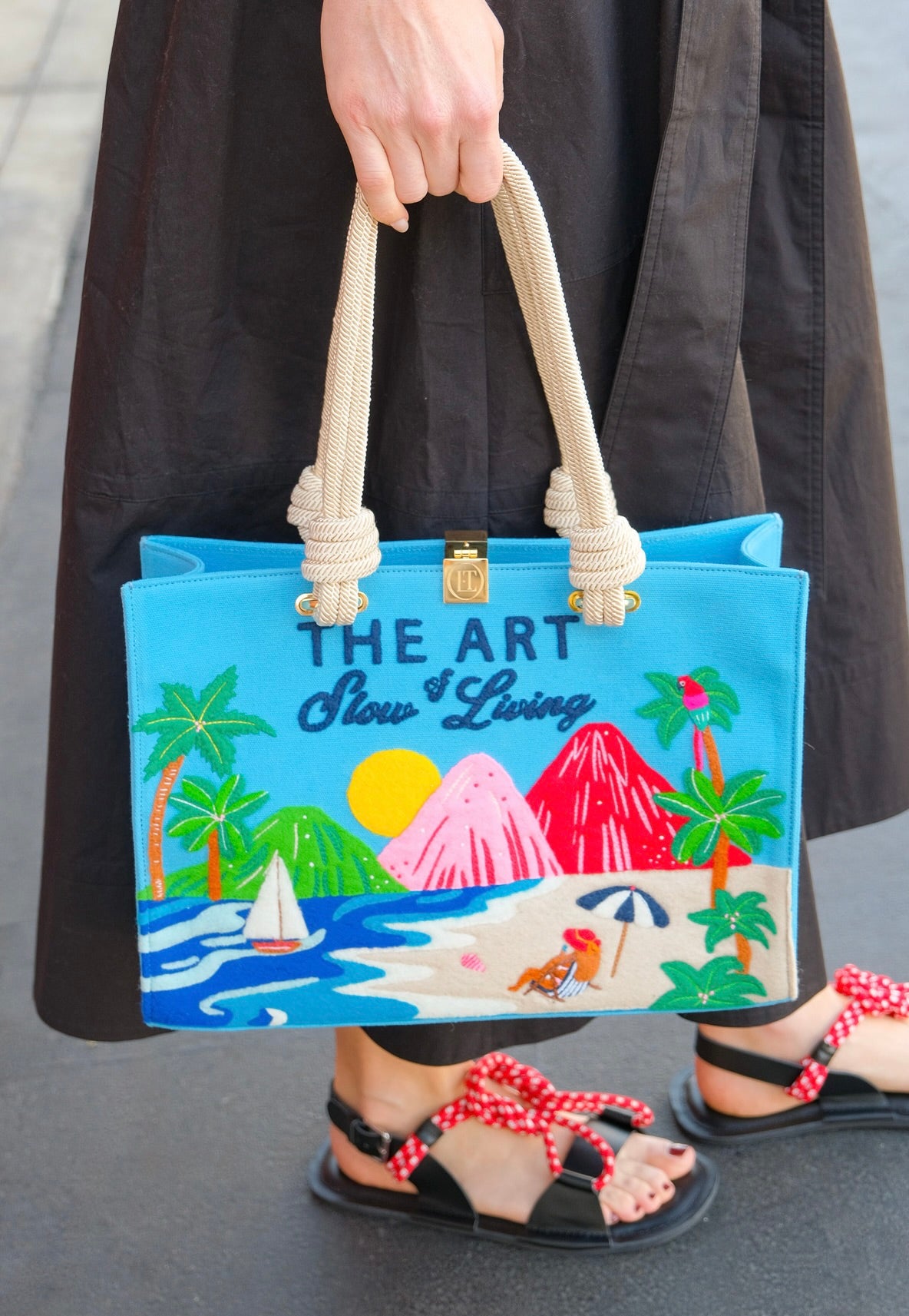 Olympia Le Tan medium sized tote with a teal background, beach design, and "The Art of Slow Living" embroidery. Available in Brentwood, CA.