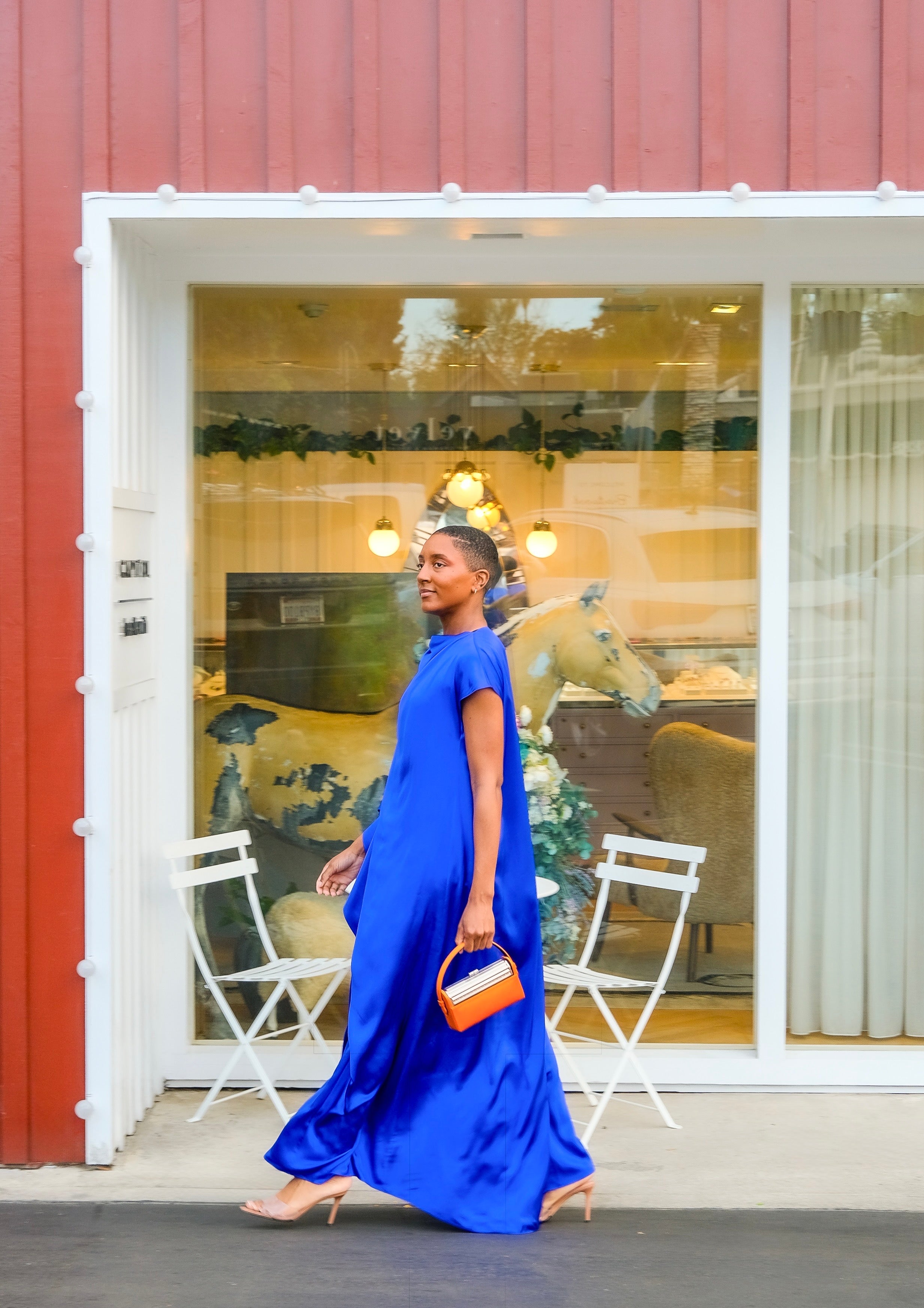 Vibrant silk draped maxi dress from Roksanda with an asymmetric cape sleeve and fluid silhouette. Available in Brentwood, CA and Charlotte, NC.