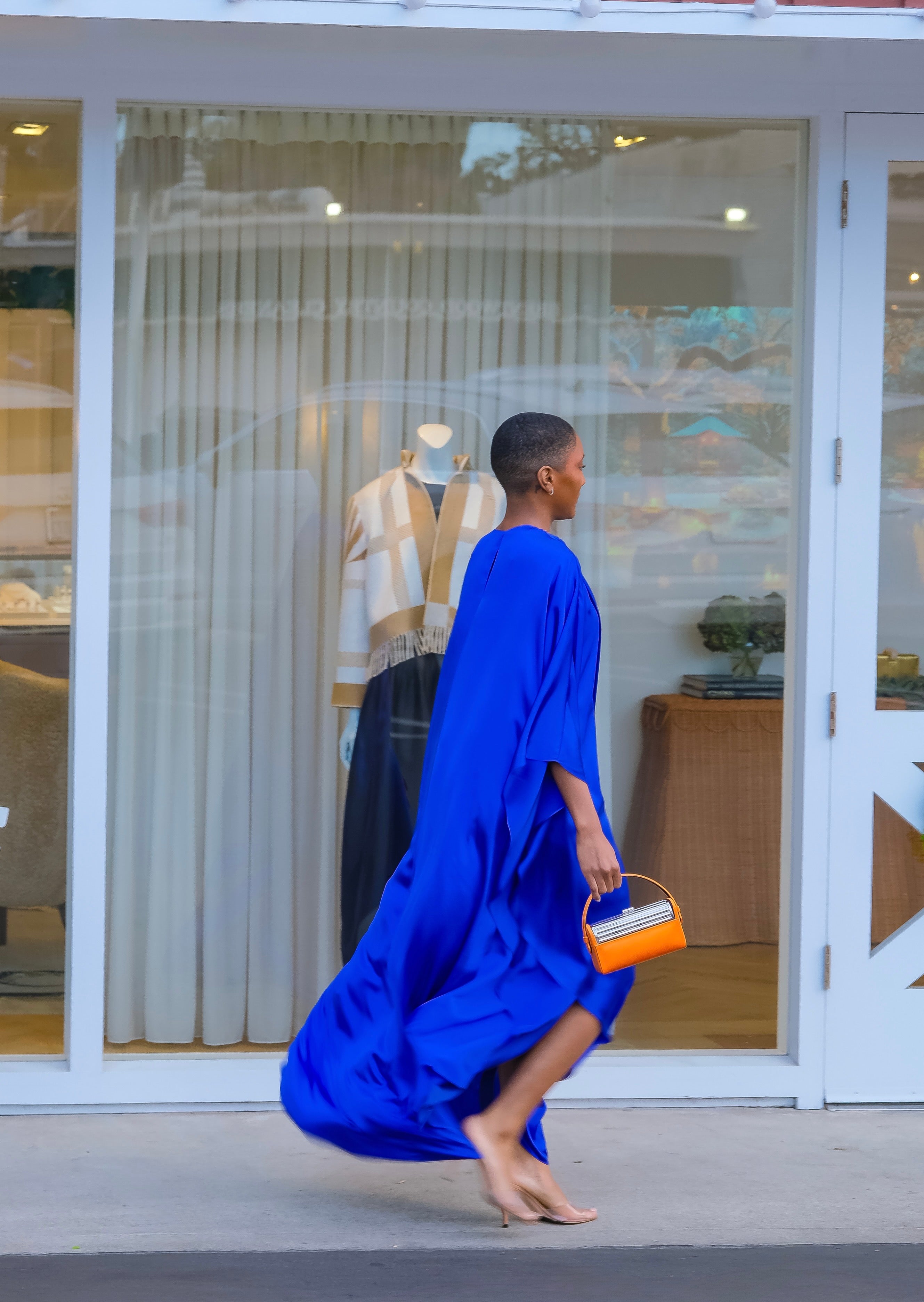 Vibrant silk draped maxi dress from Roksanda with an asymmetric cape sleeve and fluid silhouette. Available in Brentwood, CA and Charlotte, NC.