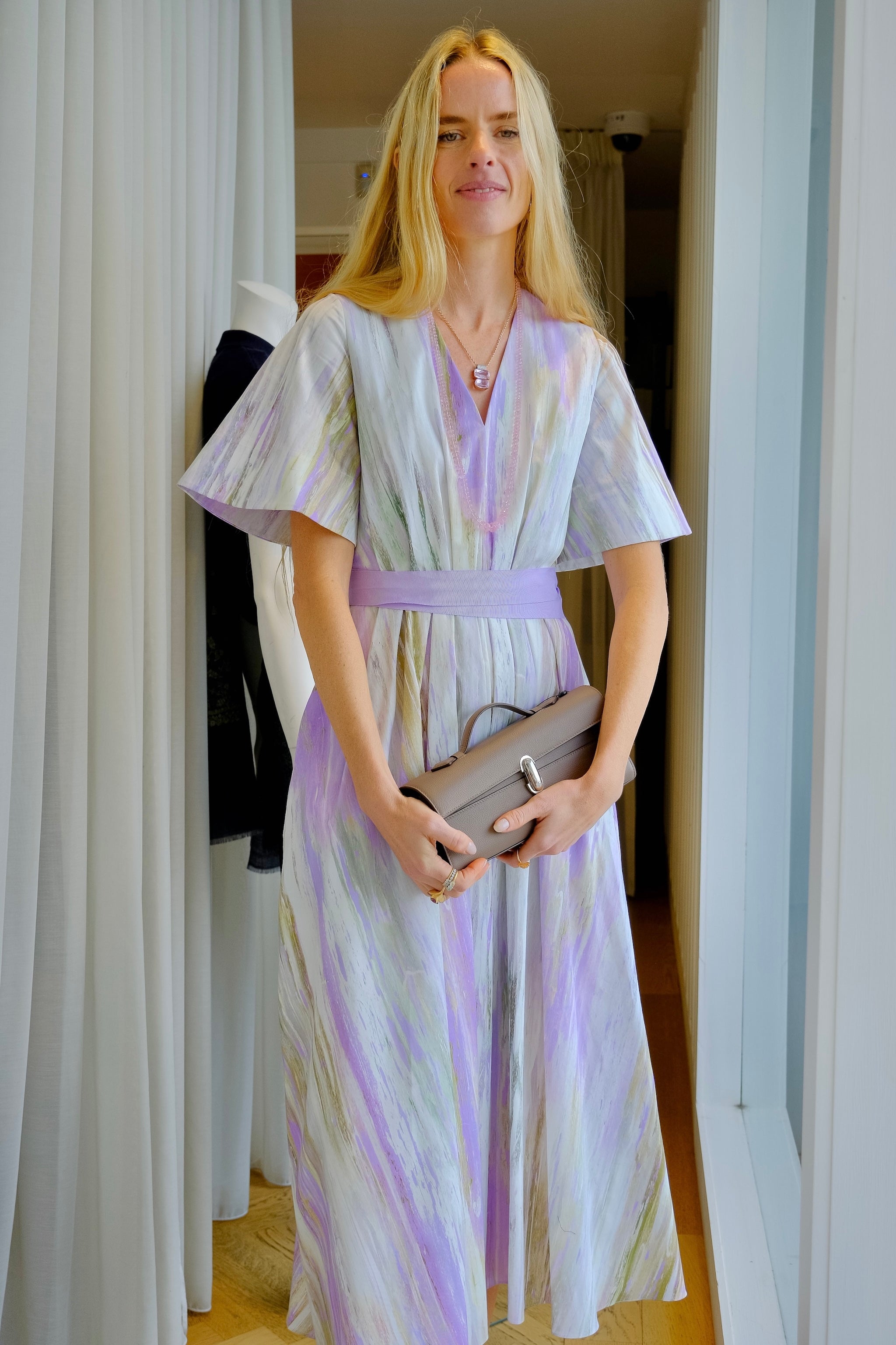 Wisteria and chalk abstract printed dress from Roksanda. Short sleeves, v-neckline, belted waist, and flowing skirt. Available in Charlotte, NC and Brentwood, CA.