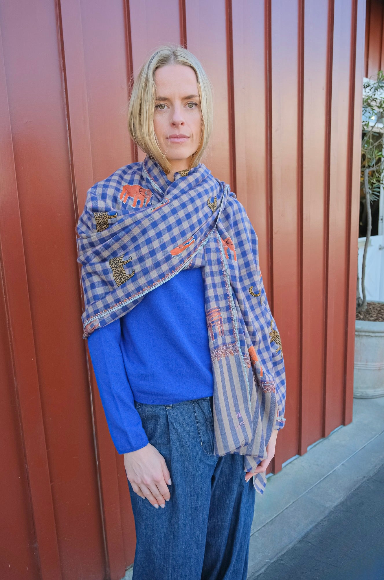 Yaser Shaw shawl with blue plaid background and Safari animal embroidery in Brentwood, CA.