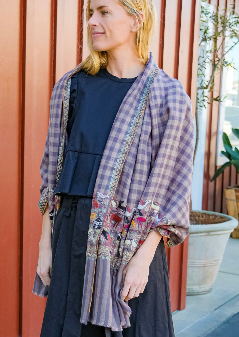 Yaser Shaw animal print safari shawl on grey plaid background. Available in Brentwood, CA and Charlotte, NC.