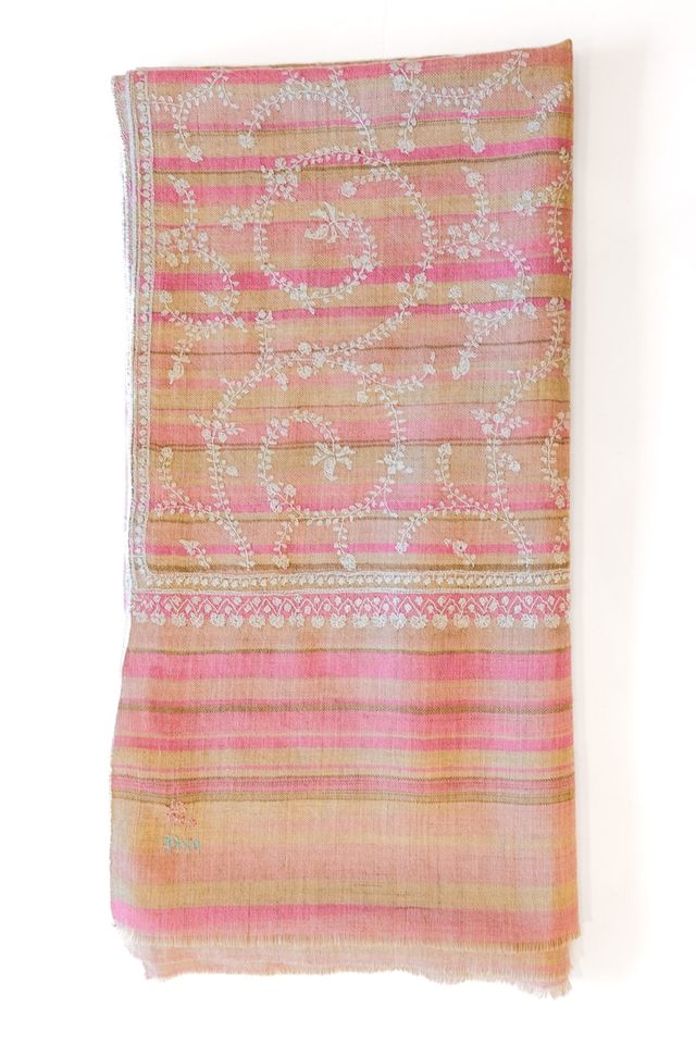 Pink and yellow patterned shawl on a white background