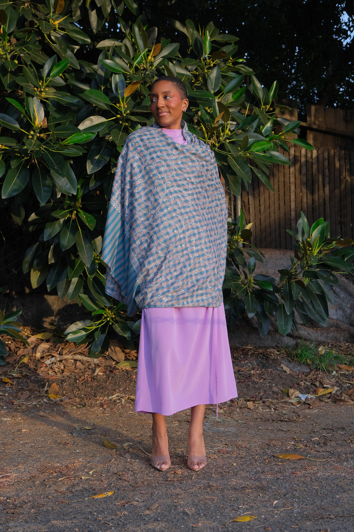 Yaser Shaw shawl with turqouise and beige check background and white vine embroidery available in Brentwood, CA.