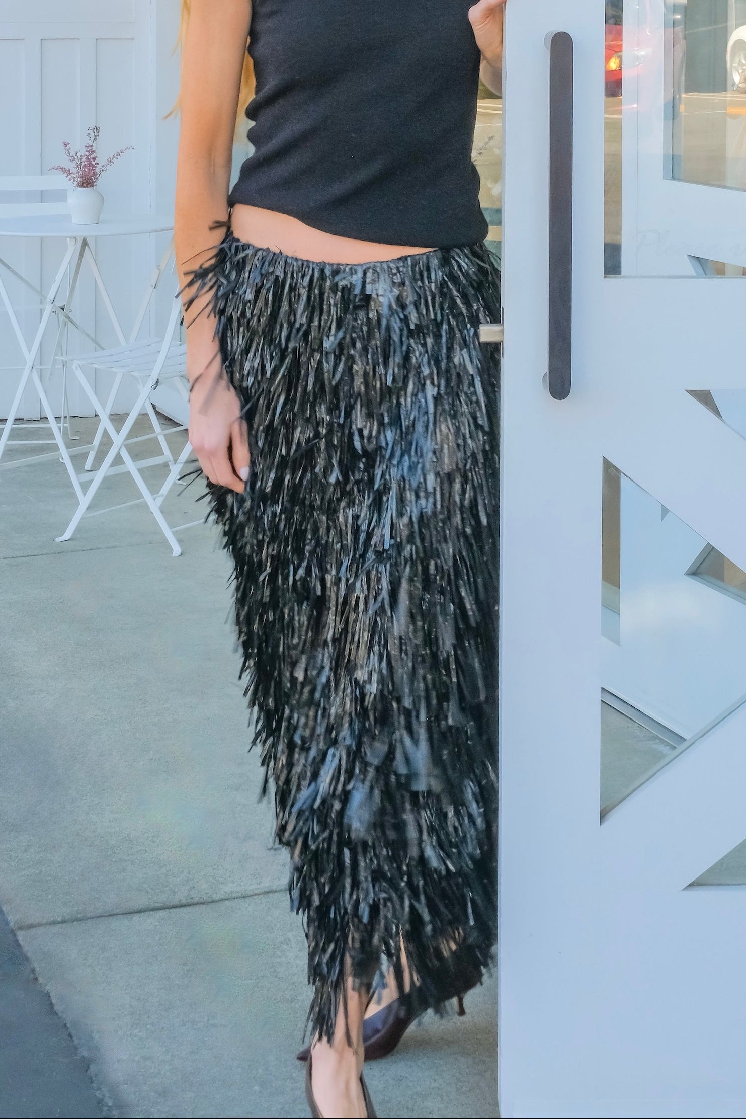 Black fringe midi skirt from CO with a slim silhouette. Available in Brentwood, CA and Charlotte, NC.