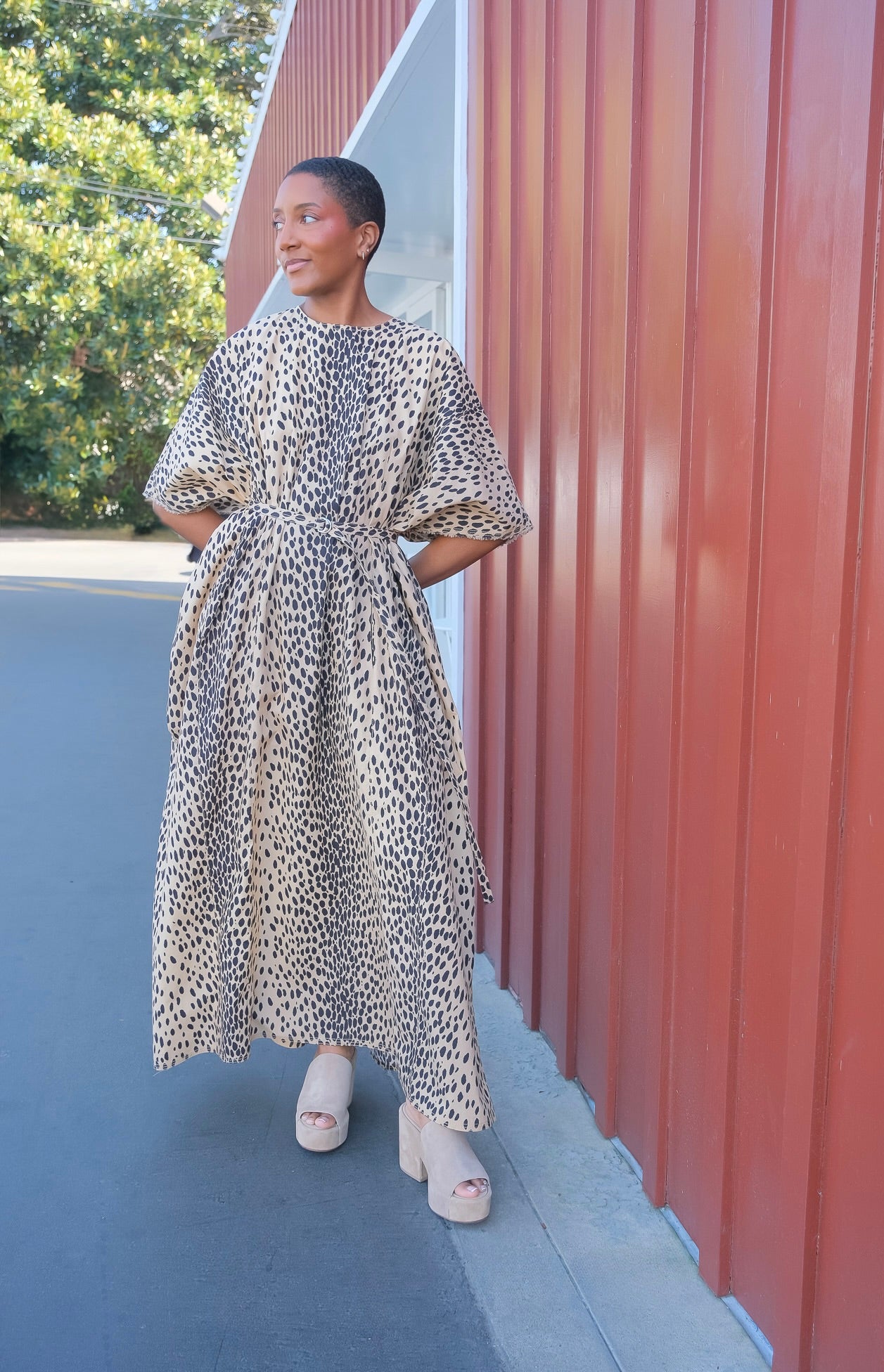 Leopard print kaftan maxi dress from Nackiye with short sleeves and a belted waist. Available in Charlotte, NC and Brentwood, CA.