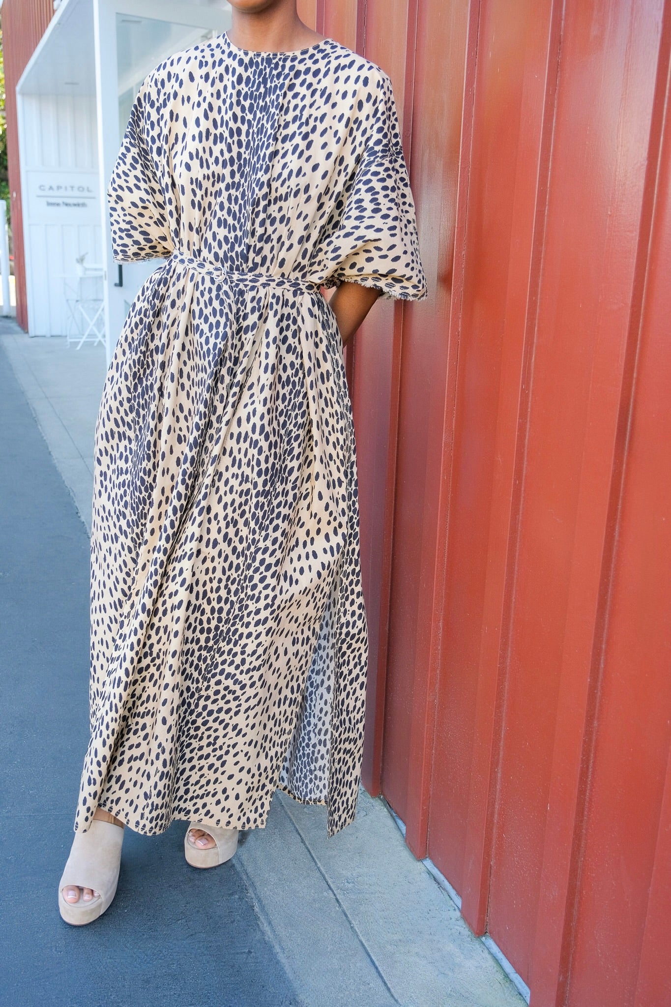 Leopard print kaftan maxi dress from Nackiye with short sleeves and a belted waist. Available in Charlotte, NC and Brentwood, CA.