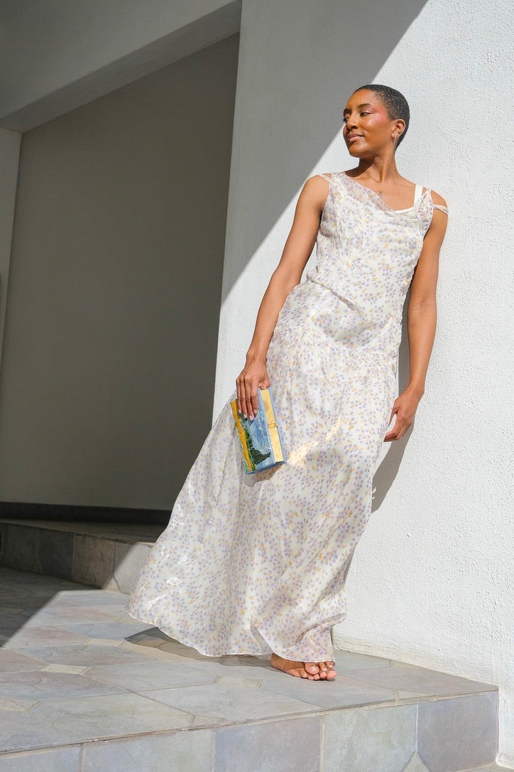 Silk chiffon dress from Plan C with a purple floral print. Asymmetrical neckline and flowing silhouette. Available in Charlotte, NC and Brentwood, CA.