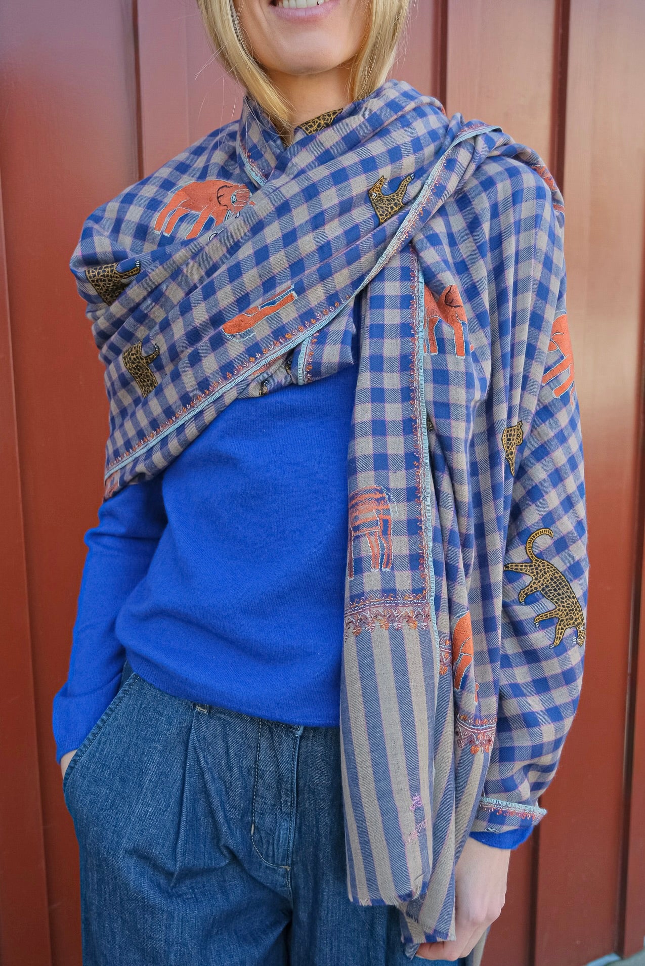 Yaser Shaw shawl with blue plaid background and Safari animal embroidery in Brentwood, CA.