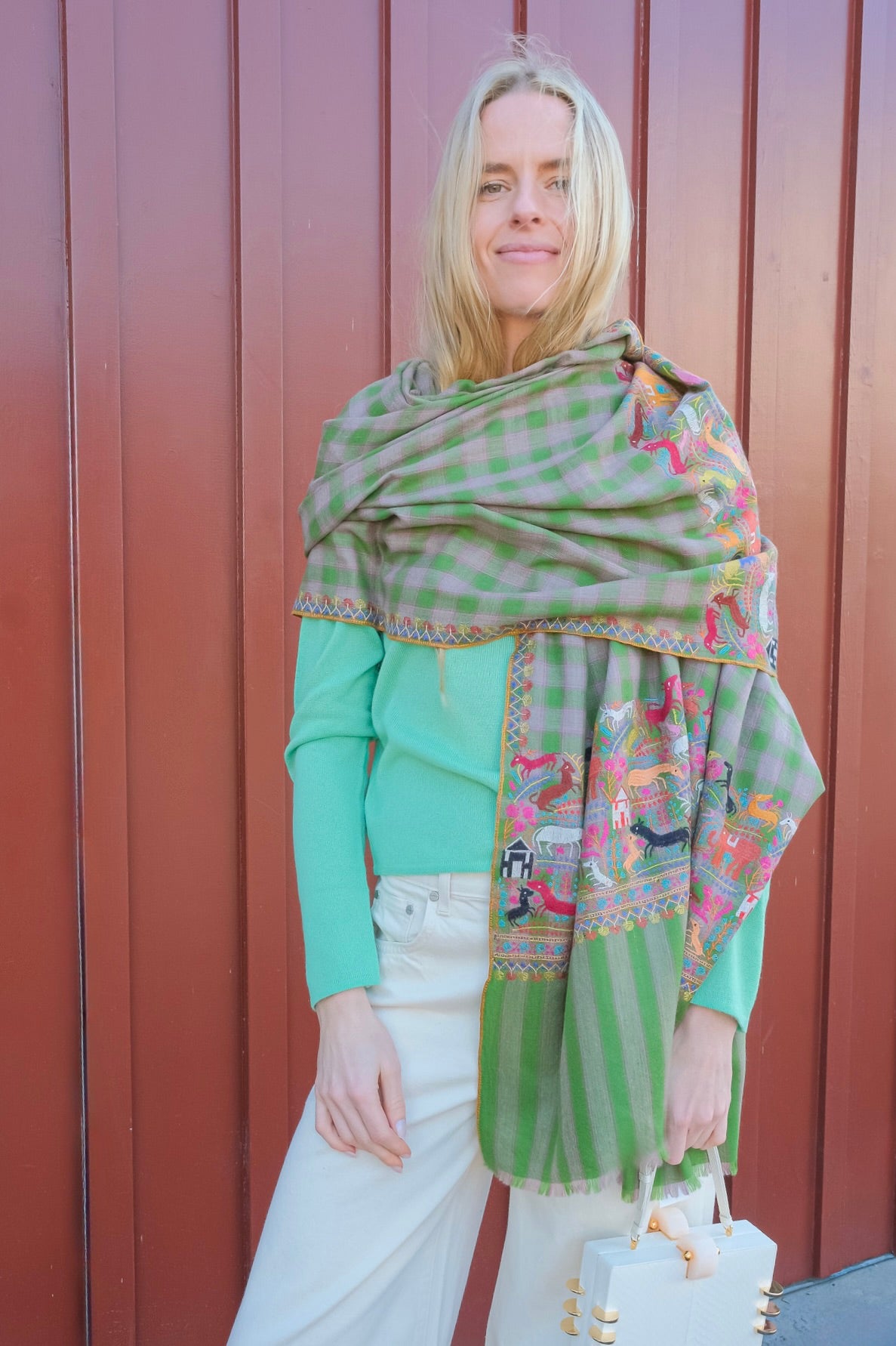 Yaser Shaw animal print shawl on green plaid background. Available in Brentwood, CA and Charlotte, NC.