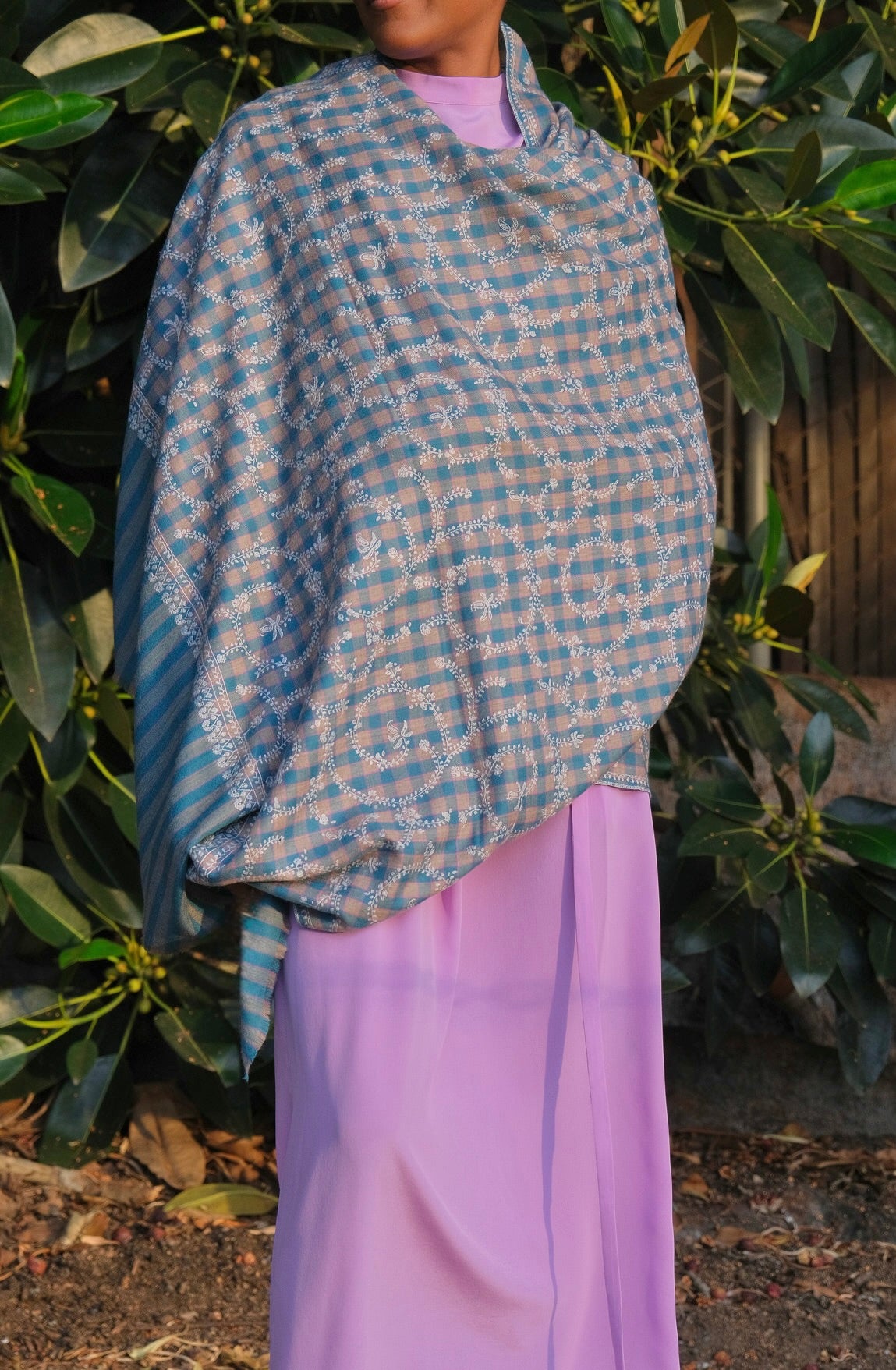 Yaser Shaw shawl with turqouise and beige check background and white vine embroidery available in Brentwood, CA.